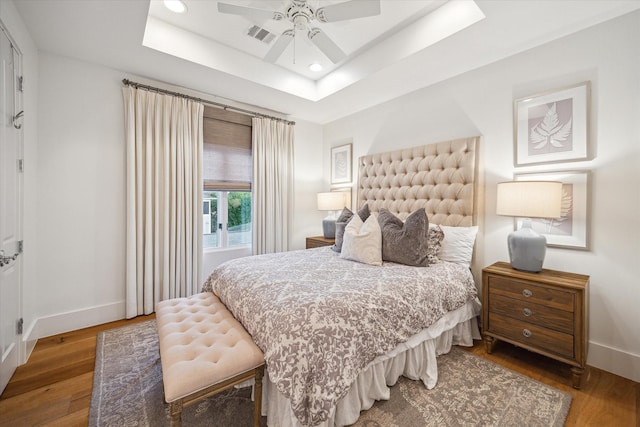 3835 Merrick St, Houston, TX 77025 - bedroom with a raised ceiling, wood finished floors, recessed lighting, and ceiling fan