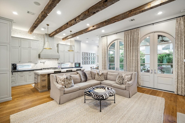 3835 Merrick St, Houston, TX 77025 - living room with healthy amount of natural light, french doors, light wood finished floors, beamed ceiling, and recessed lighting