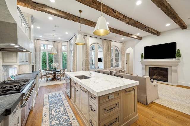 3835 Merrick St, Houston, TX 77025 - kitchen with premium range hood, light wood-type flooring, recessed lighting, beam ceiling, and a center island with sink
