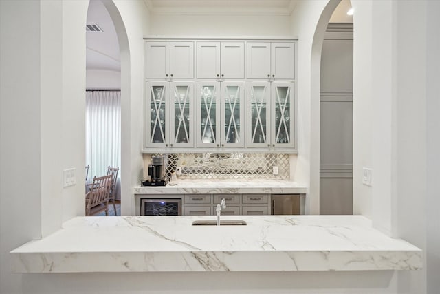 3835 Merrick St, Houston, TX 77025 - indoor bar with tasteful backsplash, arched walkways, wine cooler, and crown molding