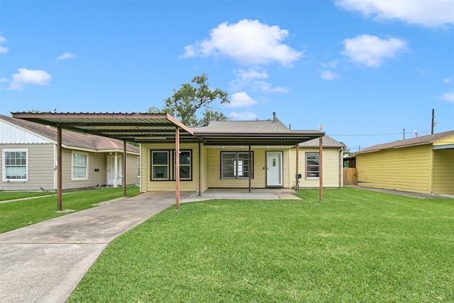 1705 13th St, Galena Park, TX 77547 - back of house with a carport, a lawn, concrete driveway, and a shingled roof