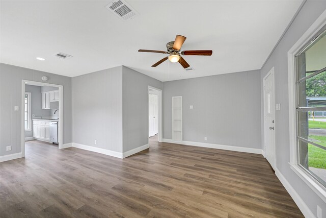 1705 13th St, Galena Park, TX 77547 - empty room with healthy amount of natural light, dark wood finished floors, and a ceiling fan