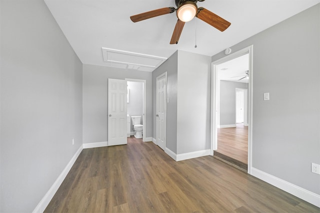 1705 13th St, Galena Park, TX 77547 - unfurnished bedroom featuring attic access, wood finished floors, ensuite bath, and ceiling fan