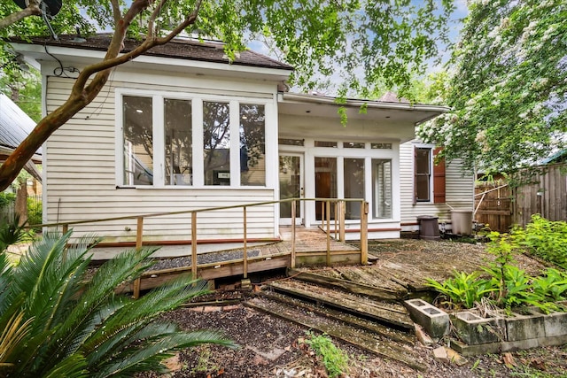 519 Bayland Ave, Houston, TX 77009 - back of house featuring a sunroom and roof with shingles