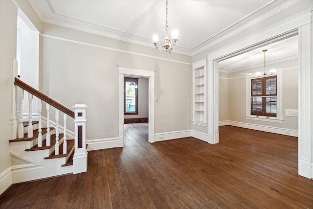 519 Bayland Ave, Houston, TX 77009 - unfurnished room featuring a chandelier, built in features, hardwood / wood-style floors, ornamental molding, and stairway