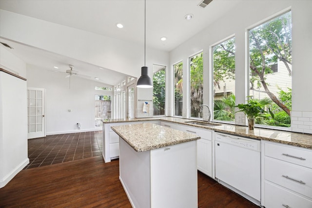 519 Bayland Ave, Houston, TX 77009 - kitchen featuring dishwasher, healthy amount of natural light, a peninsula, white cabinets, and recessed lighting