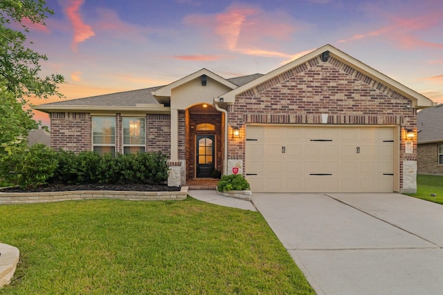 18015 Van Berkel Ln, Houston, TX 77044 - view of front facade with a garage, brick siding, driveway, a front lawn, and roof with shingles
