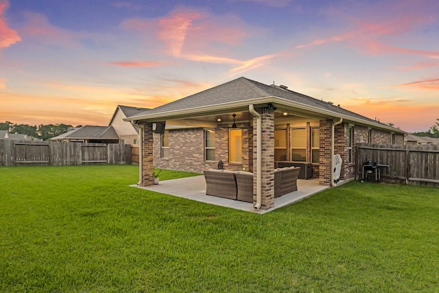 18015 Van Berkel Ln, Houston, TX 77044 - back of property at dusk featuring outdoor lounge area, a fenced backyard, a patio area, and brick siding