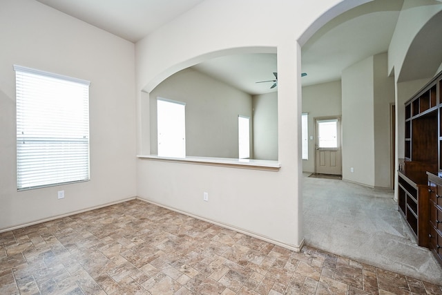 20603 Flintoff Ln, Katy, TX 77449 - unfurnished room featuring ceiling fan, stone finish floors, and arched walkways