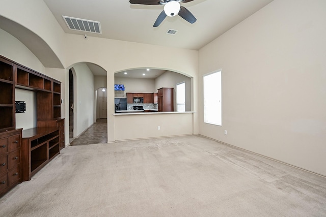 20603 Flintoff Ln, Katy, TX 77449 - unfurnished living room with light carpet, a ceiling fan, arched walkways, and recessed lighting
