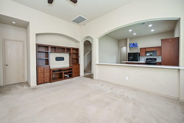 20603 Flintoff Ln, Katy, TX 77449 - unfurnished living room with a ceiling fan, light colored carpet, recessed lighting, stairs, and arched walkways