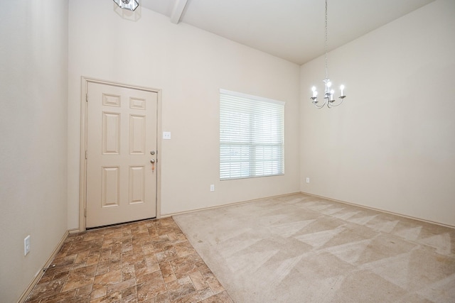 20603 Flintoff Ln, Katy, TX 77449 - entryway featuring a chandelier, stone finish flooring, and beamed ceiling
