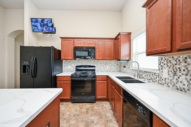 20603 Flintoff Ln, Katy, TX 77449 - kitchen with black appliances, backsplash, light stone countertops, and stone finish floors