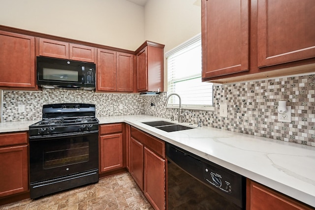 20603 Flintoff Ln, Katy, TX 77449 - kitchen with black appliances, light stone counters, and decorative backsplash