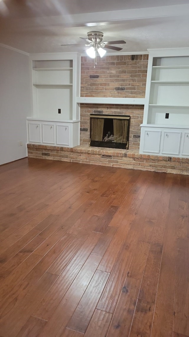 5703 Green Timbers Dr, Humble, TX 77346 - unfurnished living room with built in features, hardwood / wood-style flooring, ceiling fan, and a fireplace