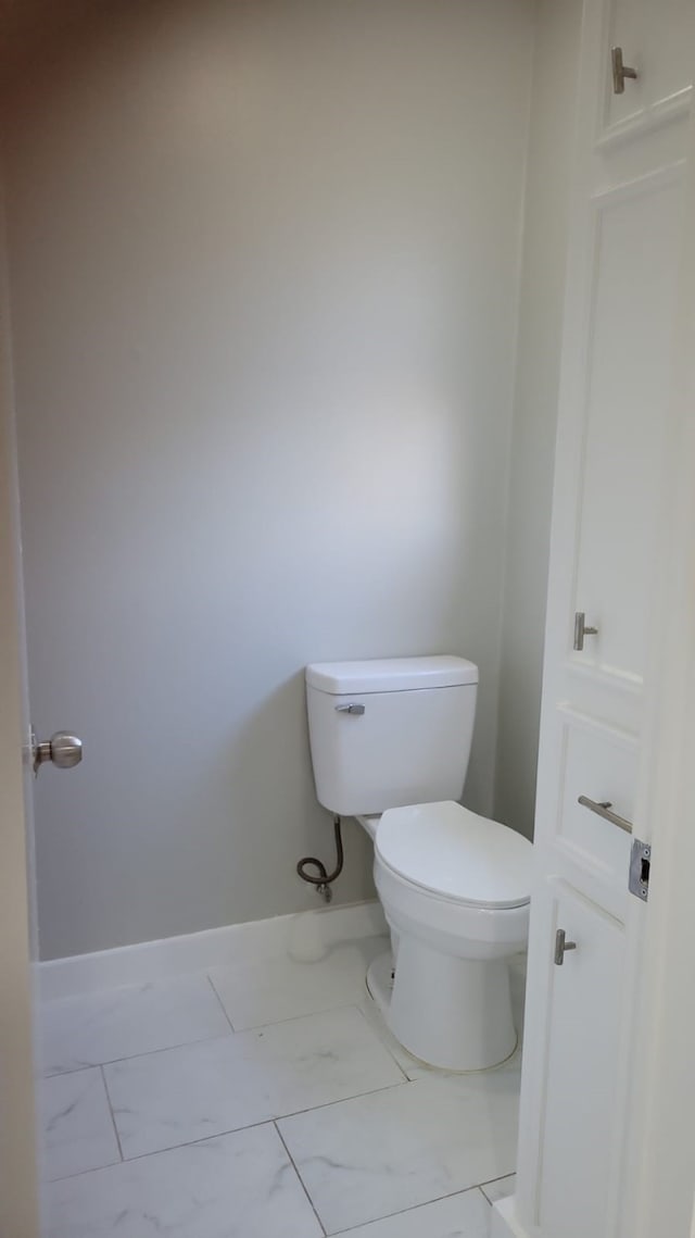 5703 Green Timbers Dr, Humble, TX 77346 - bathroom featuring marble look tile flooring and toilet