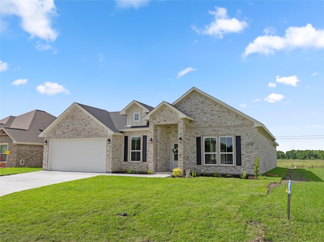 1200 Sailfish Dr, Bay City, TX 77414 - view of front of home featuring brick siding, an attached garage, concrete driveway, and a front yard