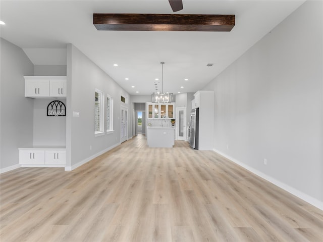 1200 Sailfish Dr, Bay City, TX 77414 - unfurnished living room featuring light wood finished floors, recessed lighting, a chandelier, and beamed ceiling
