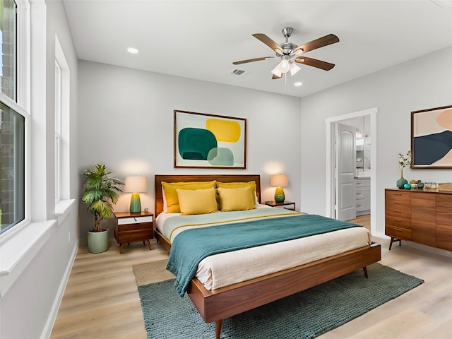 1200 Sailfish Dr, Bay City, TX 77414 - bedroom featuring light wood-style flooring, recessed lighting, a ceiling fan, and connected bathroom