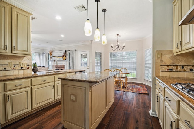 7938 S Wellington Ct, Houston, TX 77055 - kitchen featuring cream cabinets, a center island, dark wood-type flooring, backsplash, and crown molding