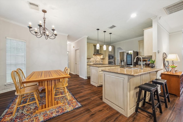 7938 S Wellington Ct, Houston, TX 77055 - kitchen with wall chimney range hood, a kitchen island, a peninsula, cream cabinetry, and dark wood-style floors