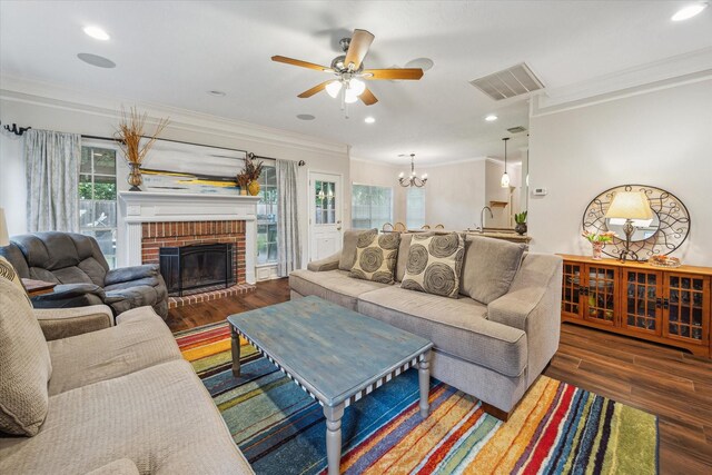 7938 S Wellington Ct, Houston, TX 77055 - living room featuring ornamental molding, healthy amount of natural light, wood finished floors, ceiling fan, and a chandelier