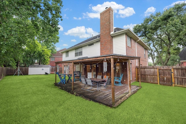 7938 S Wellington Ct, Houston, TX 77055 - back of house featuring a chimney, a wooden deck, brick siding, a fenced backyard, and a shed