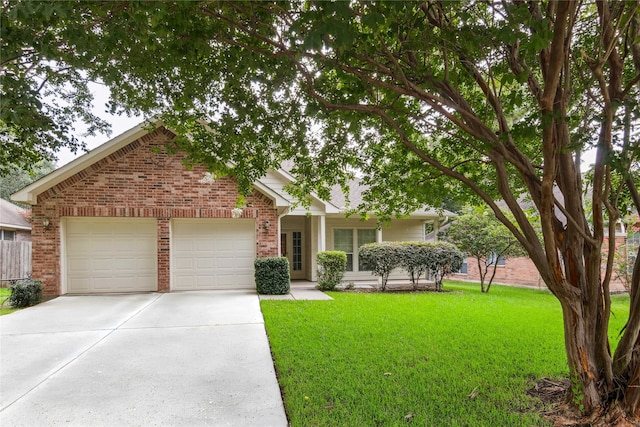 3418 Nottingham Ln, Montgomery, TX 77356 - view of front of house featuring brick siding, an attached garage, a front lawn, and driveway