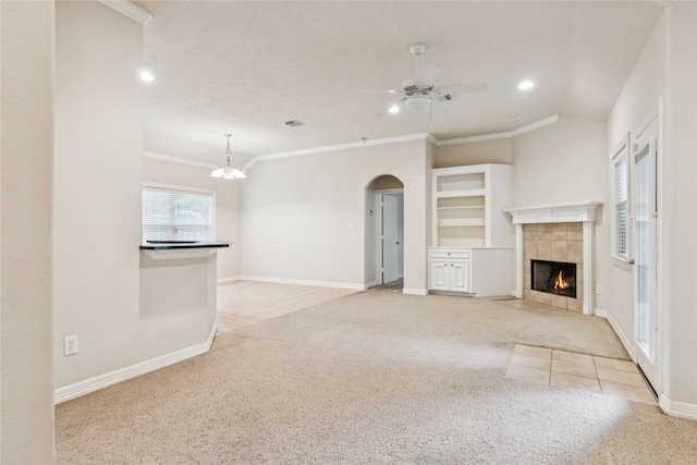 3418 Nottingham Ln, Montgomery, TX 77356 - unfurnished living room featuring light carpet, arched walkways, recessed lighting, ceiling fan, and a tile fireplace