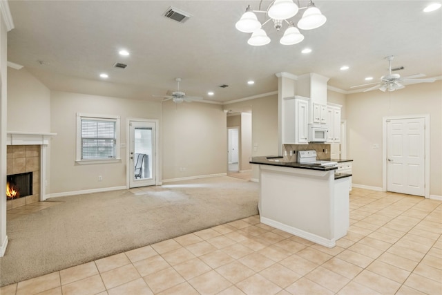3418 Nottingham Ln, Montgomery, TX 77356 - kitchen with white appliances, a ceiling fan, light carpet, dark countertops, and recessed lighting