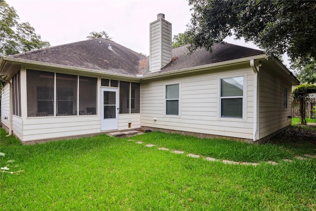 3418 Nottingham Ln, Montgomery, TX 77356 - back of property with a chimney, a sunroom, a yard, and roof with shingles