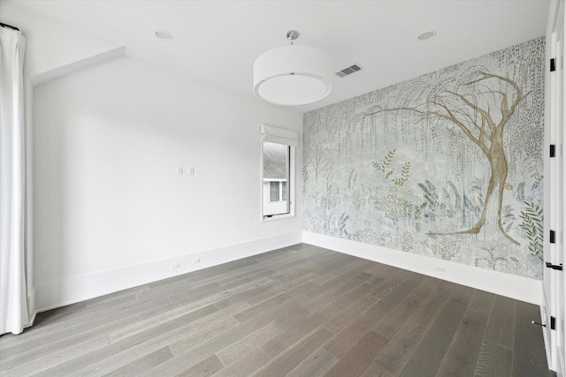 1220 Bomar St, Houston, TX 77006 - spare room featuring wallpapered walls, wood finished floors, recessed lighting, and an accent wall