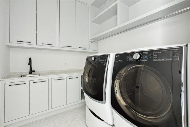 1220 Bomar St, Houston, TX 77006 - laundry area with washing machine and dryer and cabinet space