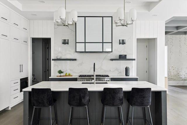 1220 Bomar St, Houston, TX 77006 - kitchen featuring a chandelier, light stone counters, and white cabinets