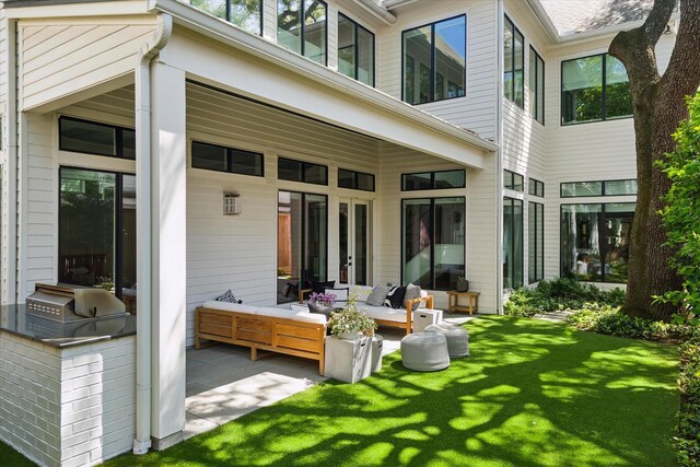 1220 Bomar St, Houston, TX 77006 - back of property with an outdoor kitchen, a lawn, a patio area, and outdoor lounge area