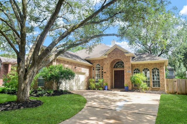 4415 Crimson Ct, Sugar Land, TX 77479 - view of front of home featuring concrete driveway, brick siding, a garage, and roof with shingles