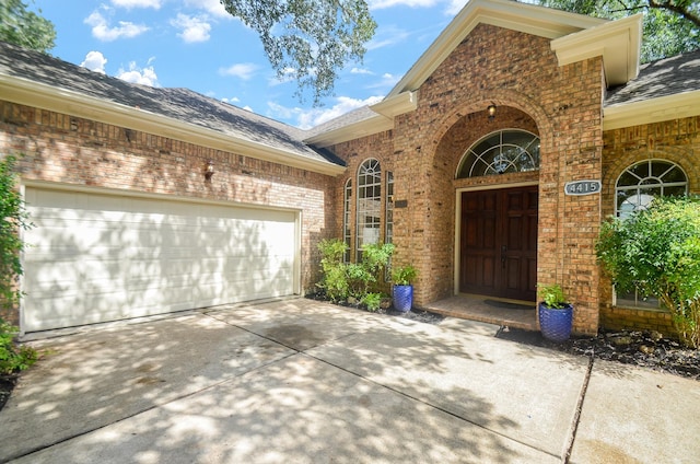4415 Crimson Ct, Sugar Land, TX 77479 - doorway to property with brick siding, concrete driveway, roof with shingles, and an attached garage