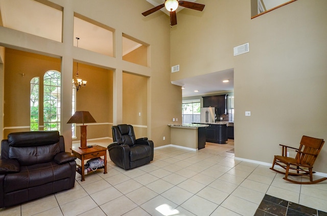 4415 Crimson Ct, Sugar Land, TX 77479 - living room with a chandelier, light tile patterned floors, ceiling fan, and a high ceiling