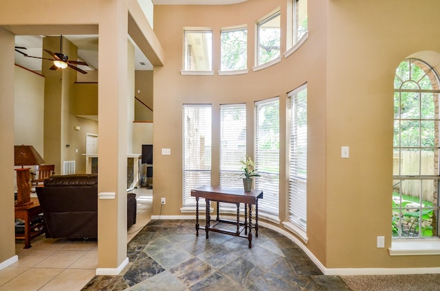 4415 Crimson Ct, Sugar Land, TX 77479 - entryway with ceiling fan, a high ceiling, and stone finish flooring
