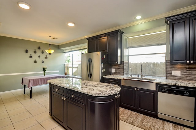 4415 Crimson Ct, Sugar Land, TX 77479 - kitchen featuring stainless steel appliances, crown molding, backsplash, light tile patterned flooring, and hanging light fixtures