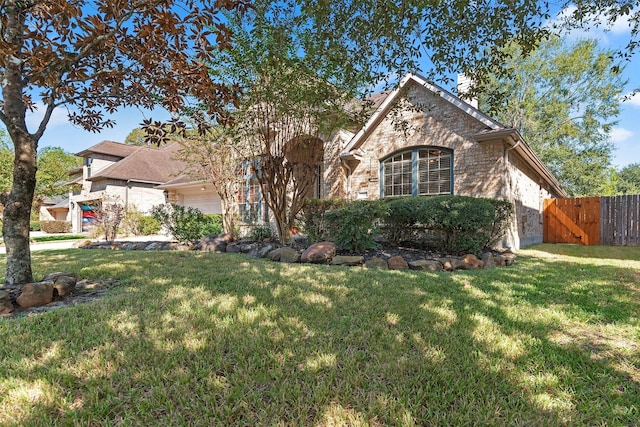 3318 Misty Alcove Ct, Kingwood, TX 77345 - view of front of house featuring an attached garage, a chimney, stone siding, and a gate