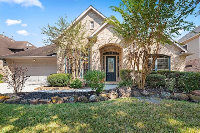 3318 Misty Alcove Ct, Kingwood, TX 77345 - view of front of home with brick siding, an attached garage, a front yard, and concrete driveway