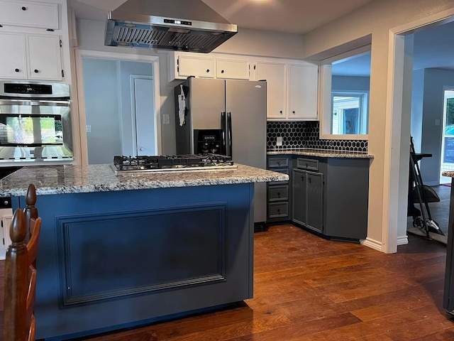230 W Lake Dr, Livingston, TX 77351 - kitchen featuring range hood, white cabinets, dark wood finished floors, tasteful backsplash, and light stone countertops