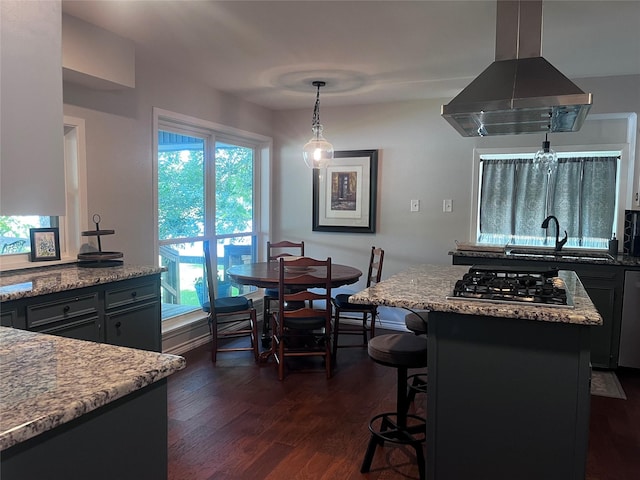 230 W Lake Dr, Livingston, TX 77351 - kitchen featuring island exhaust hood, stainless steel gas stovetop, dark wood-style flooring, pendant lighting, and a center island