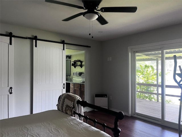 230 W Lake Dr, Livingston, TX 77351 - bedroom featuring a barn door, dark wood-style floors, ceiling fan, and ensuite bathroom