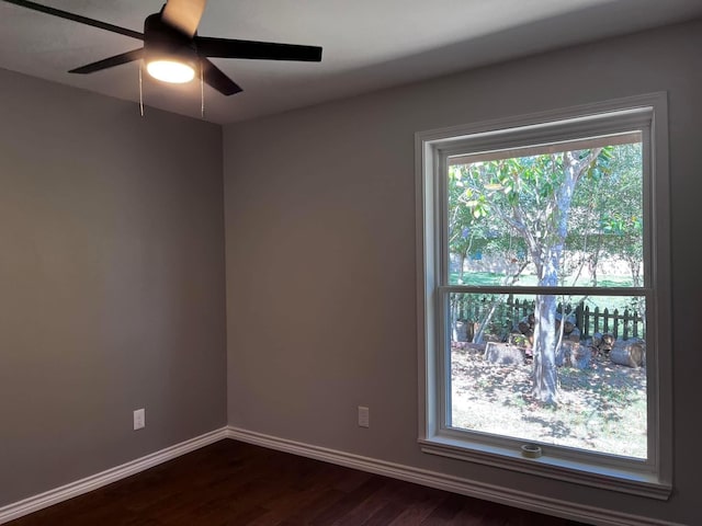 230 W Lake Dr, Livingston, TX 77351 - empty room with dark wood finished floors and a ceiling fan