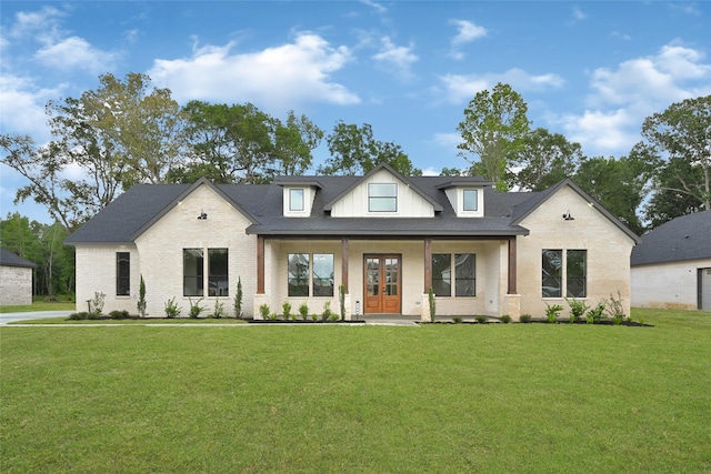 200 Rd 6615, Dayton, TX 77535 - modern farmhouse style home with brick siding, a front yard, french doors, and a porch
