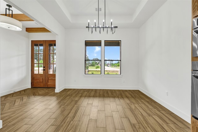 200 Rd 6615, Dayton, TX 77535 - foyer entrance featuring a raised ceiling, a chandelier, wood finished floors, and french doors