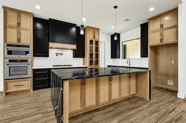 200 Rd 6615, Dayton, TX 77535 - kitchen featuring light wood-style flooring, a center island, under cabinet range hood, pendant lighting, and recessed lighting