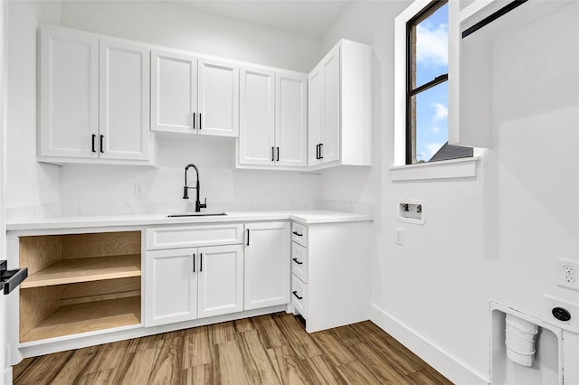 200 Rd 6615, Dayton, TX 77535 - kitchen with white cabinetry, light countertops, and light wood-type flooring